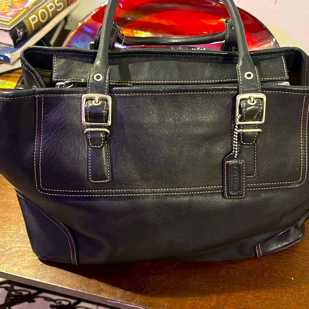 Black coach bag originally bought from Saks fifth Avenue very small flaw